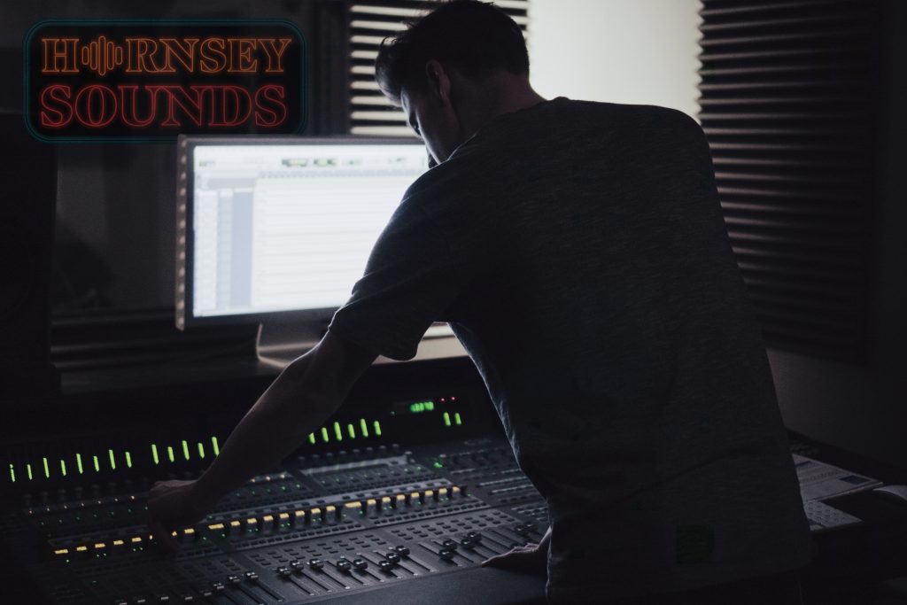 A man is working in a music studio.