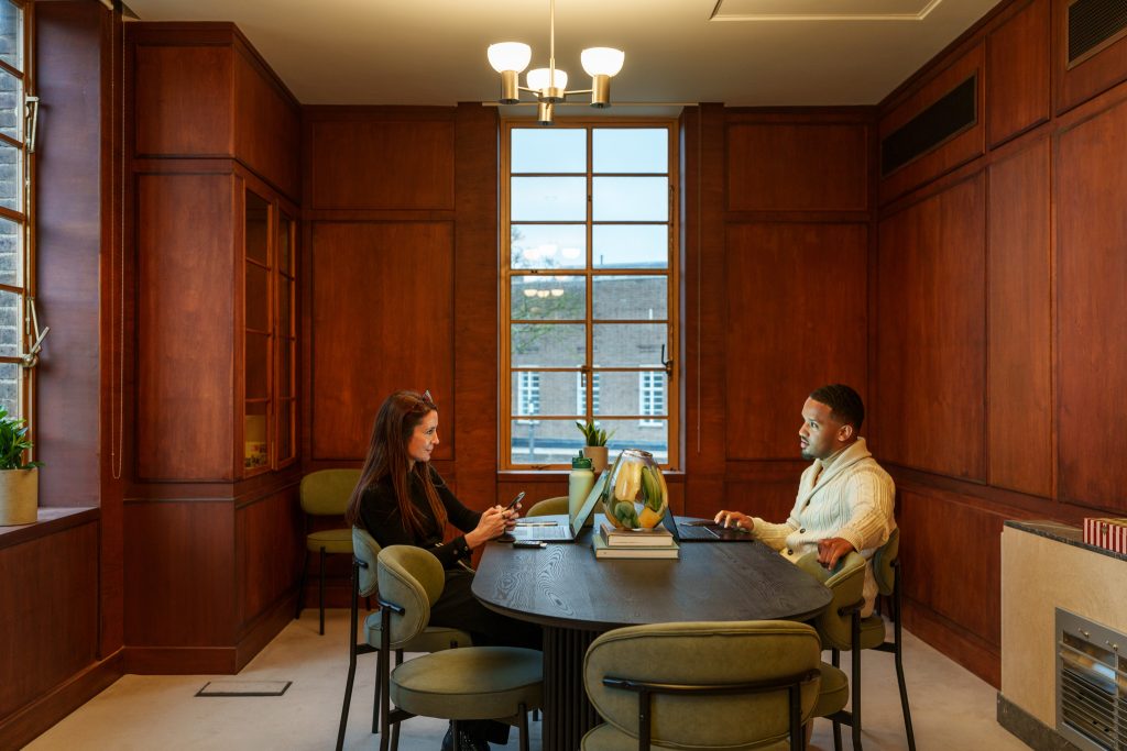 Two colleagues shown working in an art deco private office space for lease at Hornsey Town Hall.